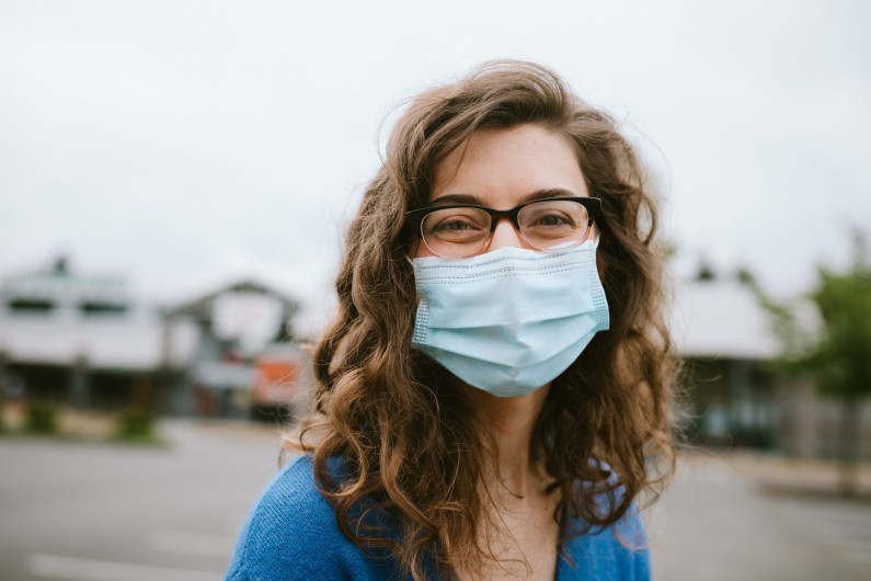 cheerful smiling woman wearing face mask scaled